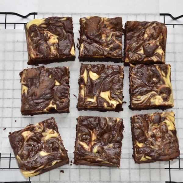 Cream cheese brownie slab cut into 9 pieces